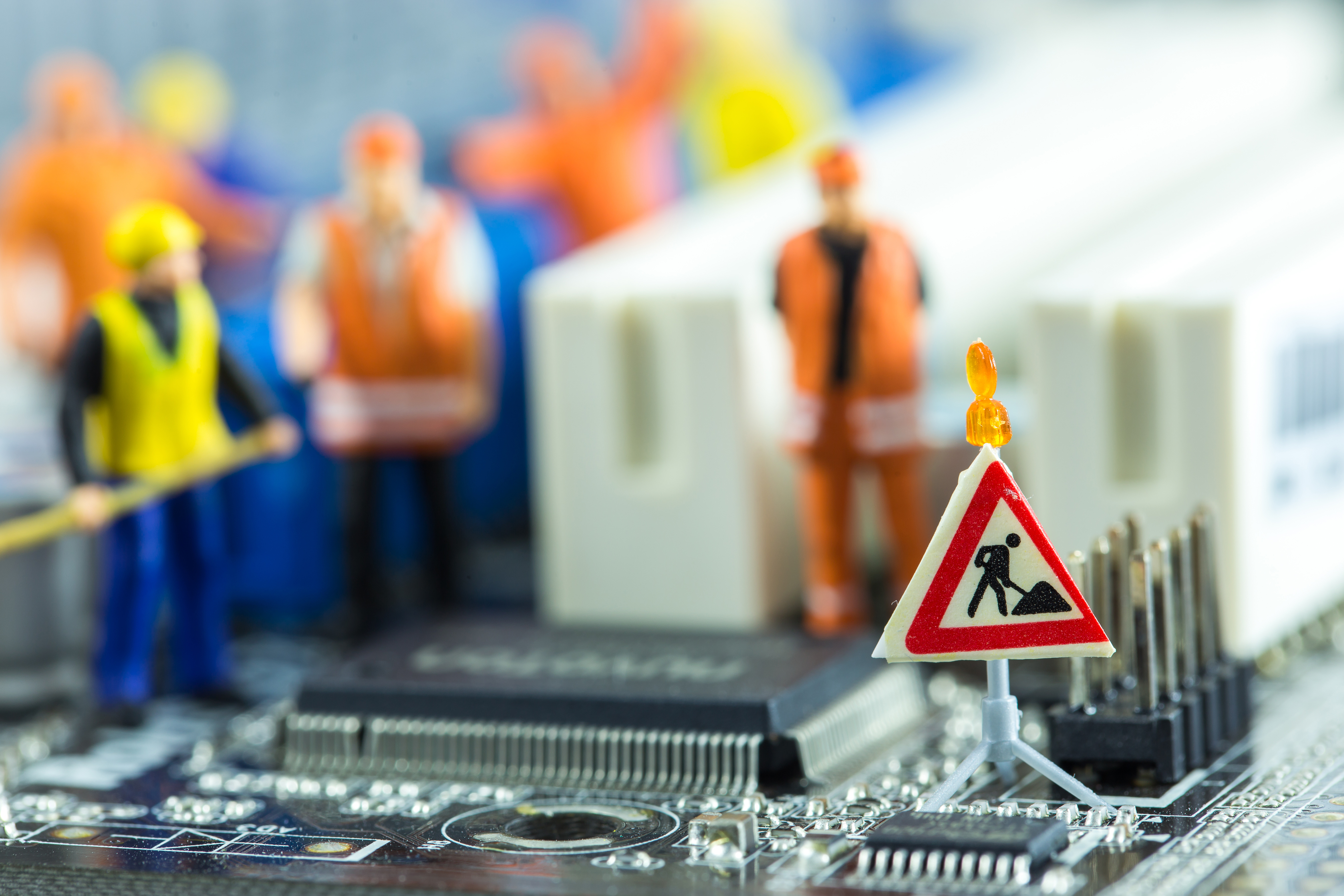Diorama of team of engineers repairing circuit mother board